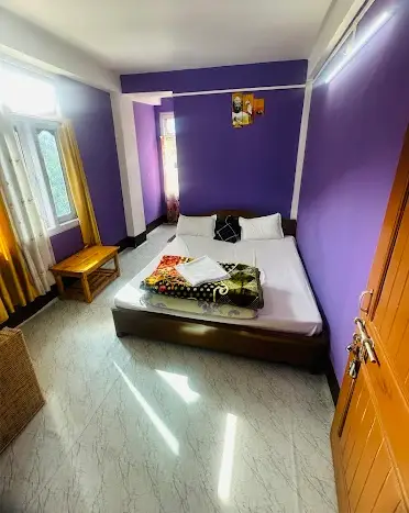Bright purple room at Yangzom Homestay in Dirang